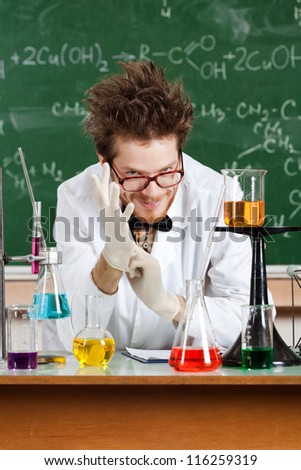 Putting rubber gloves mad professor is in his laboratory