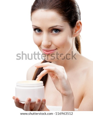 Woman holding emollient cream container and starting to apply cream, isolated on white