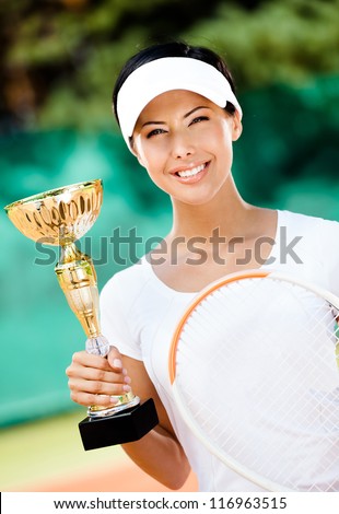 Tennis player won the cup at the sport competition. Victory