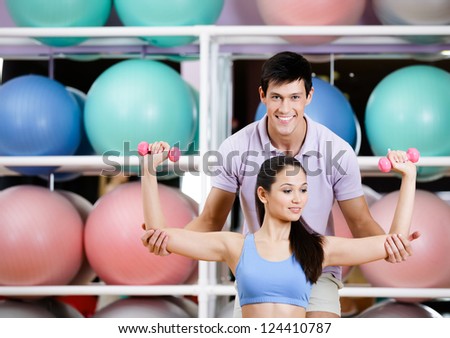 Sportive girl exercises in fitness gym with couch