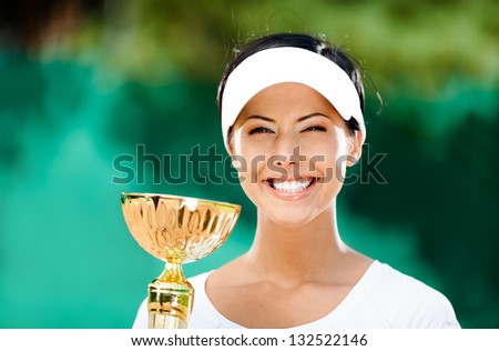 Tennis player won the cup at the sport contest. Trophy