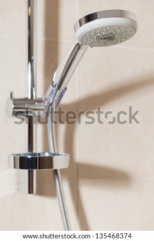 Close up view of shower head on the wall of bathroom