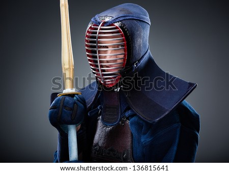 Portrait of kendo fighter with bamboo sword. Japanese martial art of sword fighting