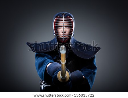 Portrait of kendo fighter with bokuto. Japanese martial art of sword fighting
