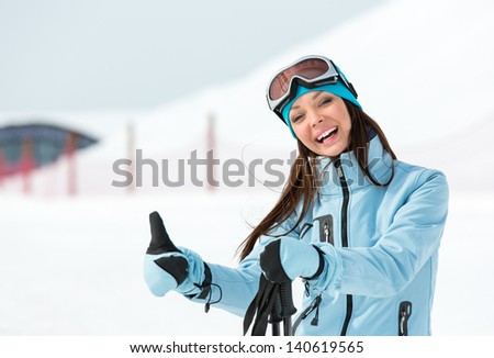 Half-length portrait of woman who goes skiing and wears goggles and sports jacket for winter sports