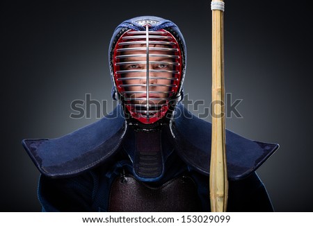 Portrait of kendoka with shinai. Asian martial arts concept