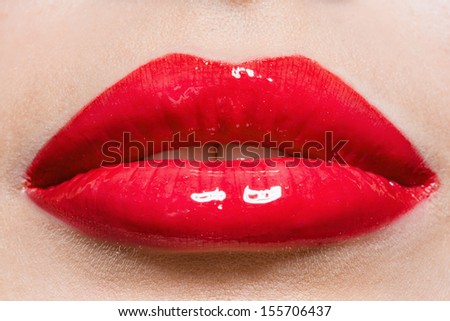 Close up of female red lips. Concept of fashion and sensuality