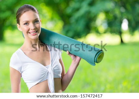 Half-length portrait of female athlete keeping mat. Concept of healthy lifestyle and sports