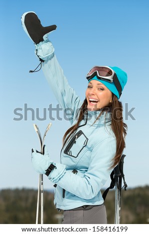 Half-length portrait of female alps skier thumbing up. Concept of winter sports and cute entertainment