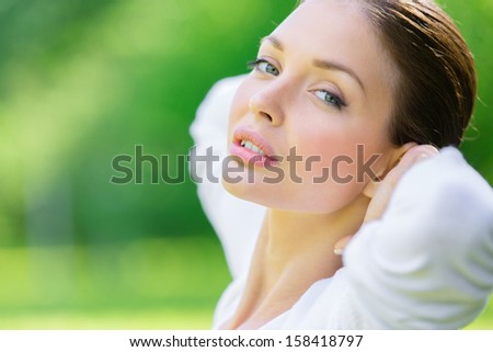 Woman putting hands behind head. Concept of healthy lifestyle and relaxation
