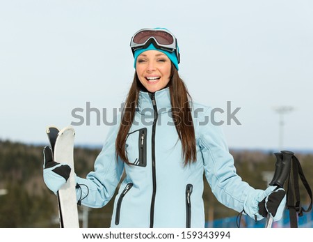 Half-length portrait of female alps skier. Concept of winter sports and cute entertainment