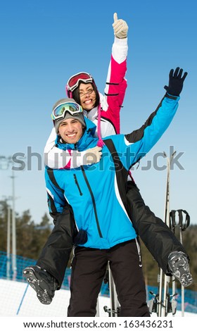 Half-length portrait of happy couple of downhill skiers have fun. Concept of winter sports and cute vacations