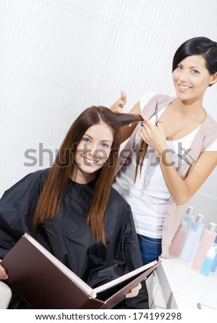 Hairdresser cuts hair of woman in hairdresser\'s. Concept of fashion and care