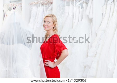 Pretty girl examines wedding dress and dreams about happy future