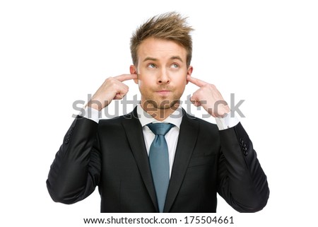 Half-length portrait of businessman closes his ears, isolated on white. Concept of noise and stress