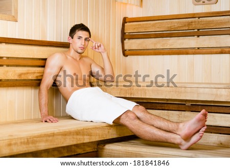 Half-naked man relaxing in sauna. Concept of self-care, health and relaxation