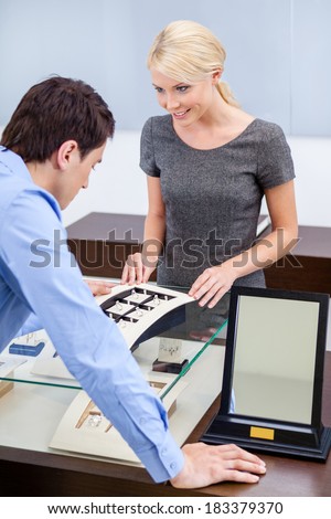 Man choosing engagement ring at jeweler\'s shop. Concept of wealth and luxurious life
