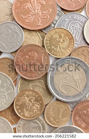Scattering silver and gold coins. A great number of coins symbolize wealth, richness, income and profit. Close up shot.