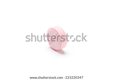 Pink tablet, isolated on white. Healthcare concept.