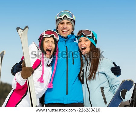 Half-length portrait of group of embracing skier friends. Concept of cute winter sport and funny vacations with friends