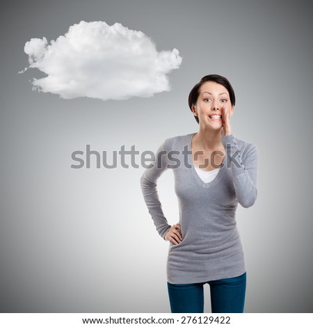 Pretty woman whispers, isolated on grey background