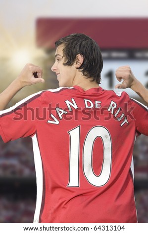 Soccer player is pointing at his back