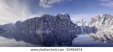Snowy mountain reflected on water