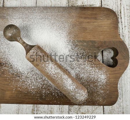 Wooden Rolling Pin With Flour On A Wooden Board