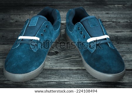 dark blue man\'s shoe on wooden background