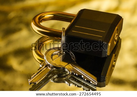 hinged lock with keys on golden background