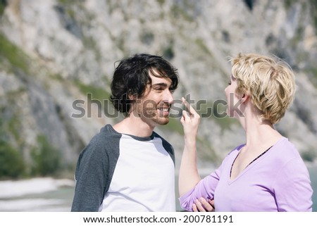 Germany, Bavaria, young couple woman touching man\'s nose teasing