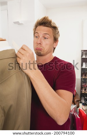 Surprised man looking at price tag
