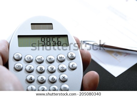 Calculator in hand, bank transfer and ball pen