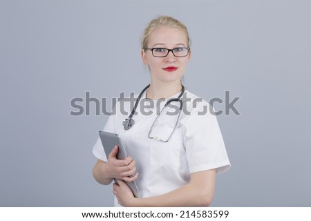 Proud young female doctor holding tablet