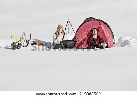 Austria, Salzburger Land, Couple camping in snow covered landscape