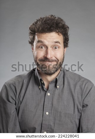 Man in grey shirt pulling funny face