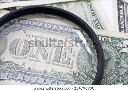 US Dollar bills seen through magnifying glass, close up