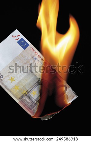 50 euro note burning against black background