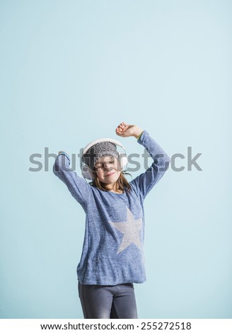 Girl with head phones dancing and listening to music