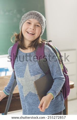 Confident girl with tablet pc in class room