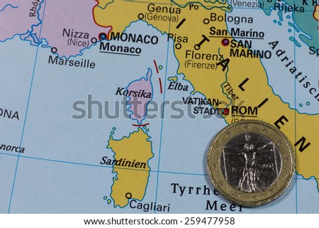 One euro coin on map, Italy