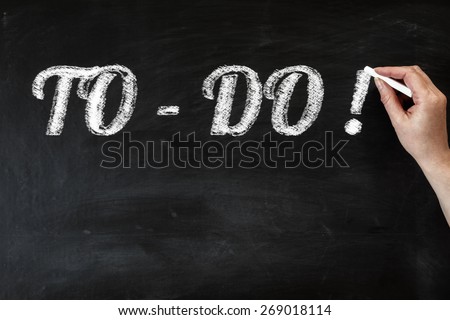 Hand writing to do list with chalk on black board