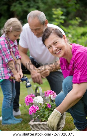 Family watering flowers in flower box