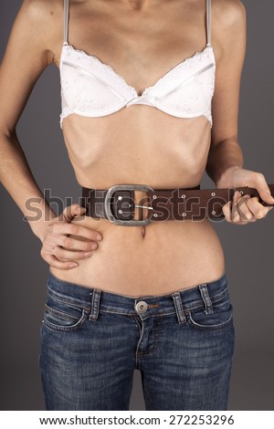 Anorexic woman, bell on belly