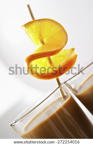 Latte Macchiato with orange peel on skewer