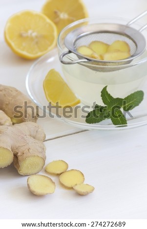 Ginger tea with lemon and mint in tea cup
