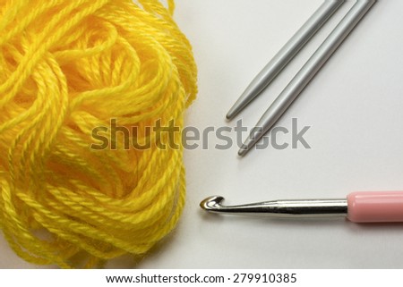 Wool with crocheting hook and knitting needles