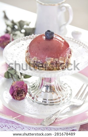 Small biscuit cake with blueberry cream, blueberry and cake glaze