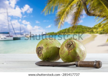 Coconuts with cleaver on wood, Caribbean beach
