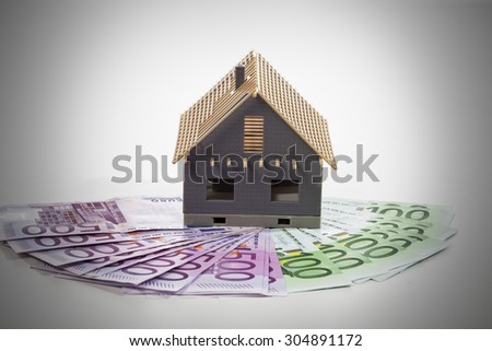 Model house on fanned euro notes